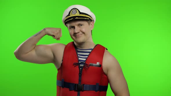 Young Muscular Sailor Man Works As Lifeguard at Beach Shows Muscles. Chroma Key