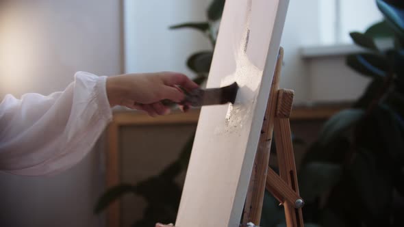 Young Woman Artist Drawing a Painting  Applying First Colors on the Canvas