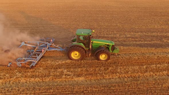 Tractor with Plough in Motion.