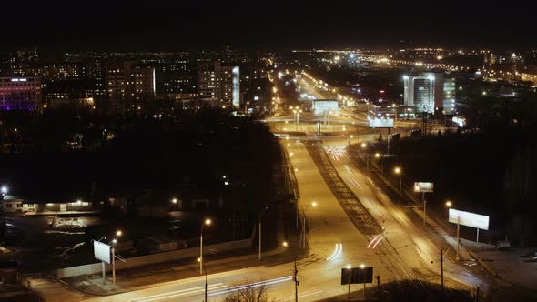 City Traffic At Night, Time Lapse. The Cars Are Moving Upon the Road Very Fast