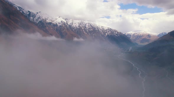 Magnificent Aerial View of Dariali Gorge From the Clouds Border Between Georgia and Russia