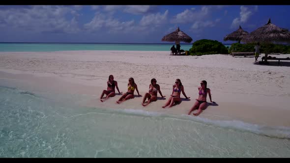 Beautiful ladies tanning on relaxing sea view beach vacation by blue ocean with clean sand backgroun