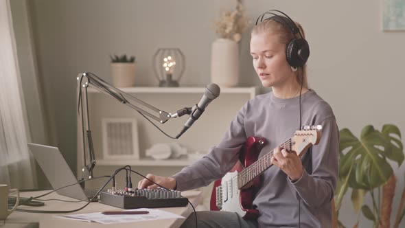 Young Woman Recording Song at Home