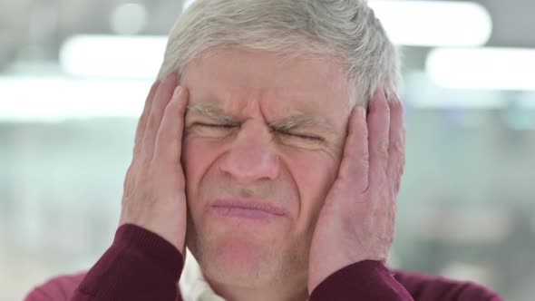 Close Up of Middle Aged Man with Headache 