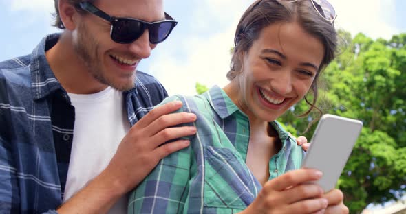 Friends using mobile phone alt