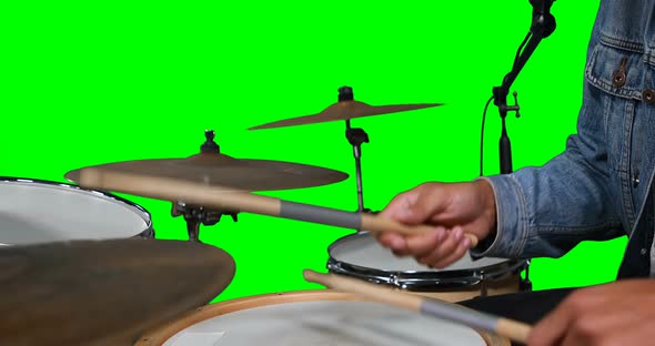 Mid section of drummer playing drum