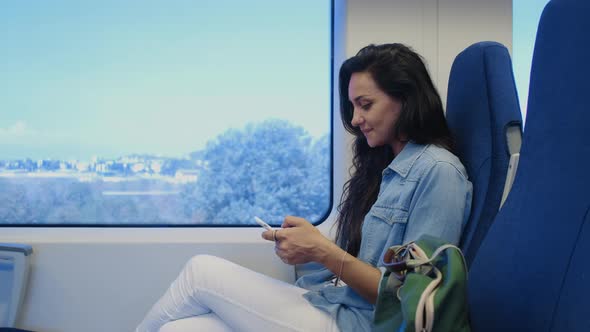 Woman Chatting on Mobile During Train Ride