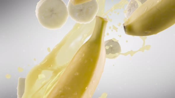 Banana with Slices Falling on Grey Background