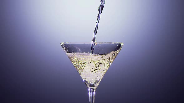 Alcohol Drink Is Poured Into Tall Martini Glass. Slow Motion