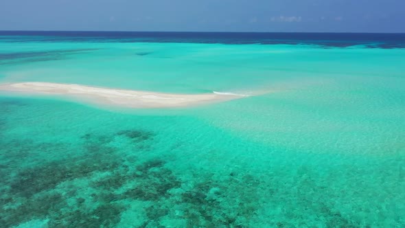 Aerial above panorama of tranquil resort beach vacation by blue ocean and bright sand background of 