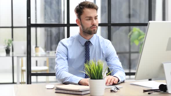 Portrait of handsome businessman working using computer in office and pretty face looking at camera