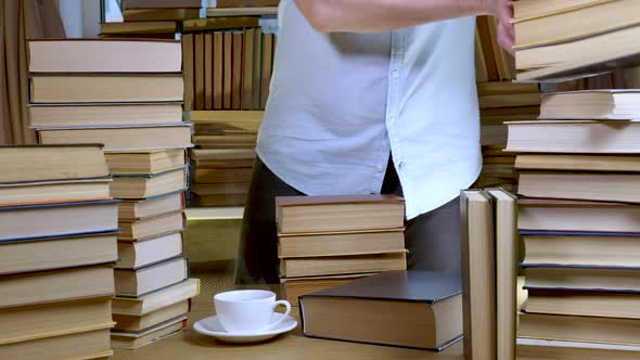 A Bearded Man Reads a Book in the Library