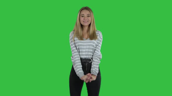 Blonde Girl with Long Hair Is Clapping Her Hands and Tender Smiling on Green Screen