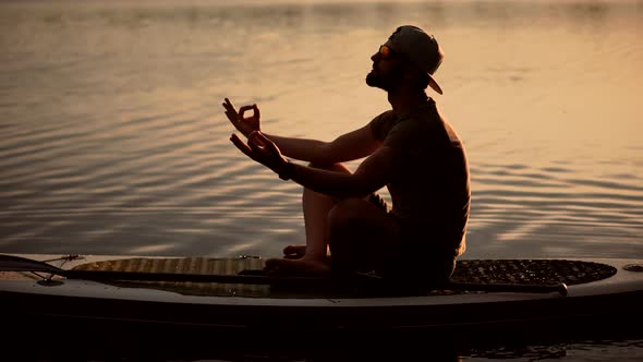 Tourist Meditation Pose Sup Board On Vacation.Standup Paddle Board.Cross-Legged No Stress Leisure