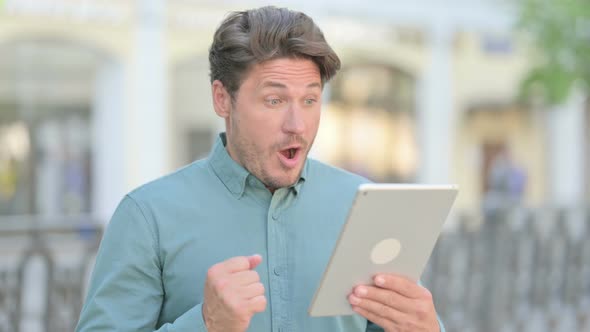 Man Celebrating on Tablet Outdoor