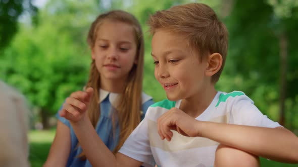 Boy Caressing White Dog on Picnic Close Up