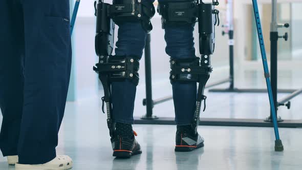 A Person is Walking in the Exoskeleton with Assistance