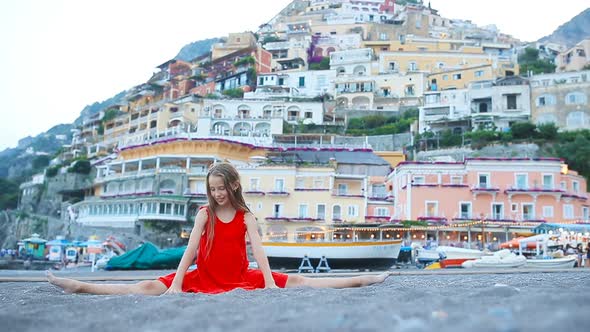 Adorable Little Girl on Warm and Sunny Summer Day in Positano Town in Italy