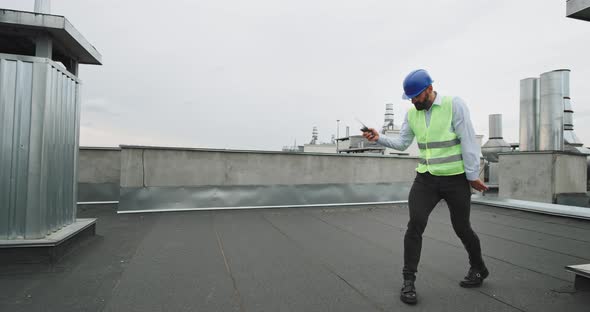 Businessman or Engineer in a Safety Helmet Dancing