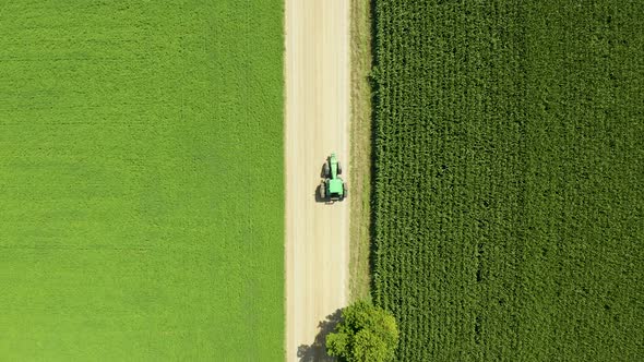 Drone video of tractor driving down a road