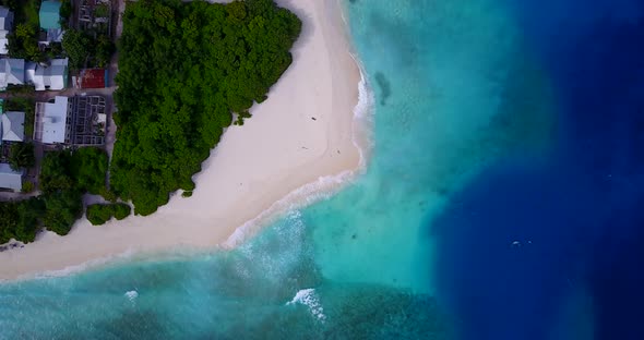Wide angle above abstract shot of a sandy white paradise beach and aqua blue water background in col