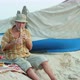Senior man playing bamboo flute on the beach next to fishing boat - VideoHive Item for Sale