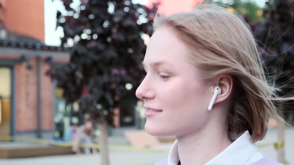 Young Woman with Short Fair Hair and Wireless Headphones