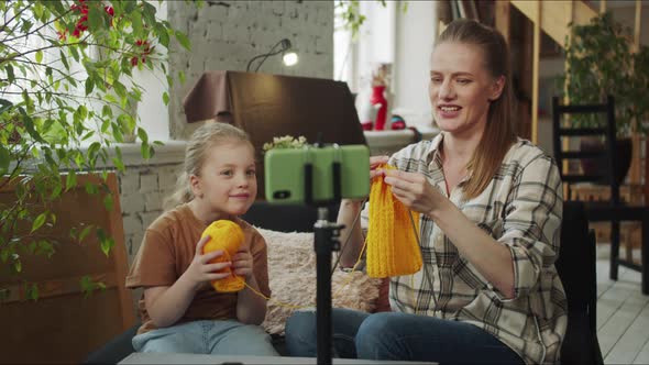 Mom and Daughter are Knitting in Front of the Camera