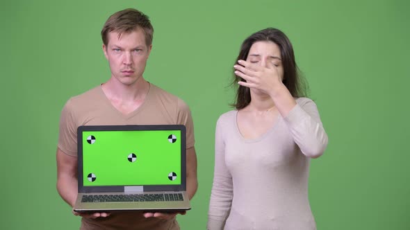 Young Couple Showing Laptop and Getting Bad News Together