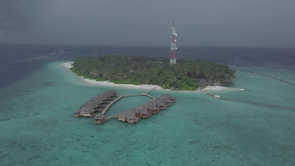 Aerial view of luxury bungalows on water, Island resort villas in Indian ocean, Maldives from drone