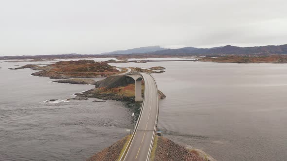 Aerial View Of Famous Atlantic Ocean Road With Cloudy Sky in Norway. - Drone shot, pull in