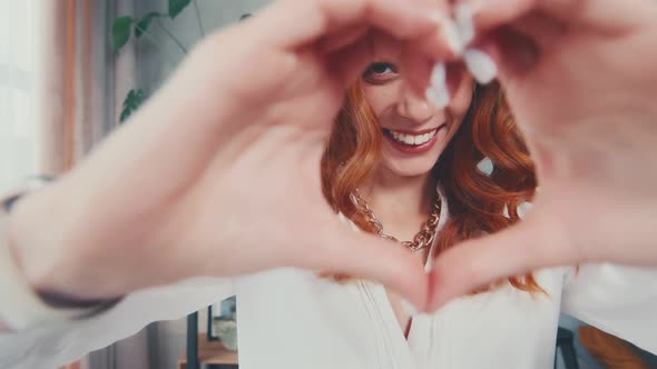 Happy Caucasian Woman Gesture in Form of Heart Showing Love and Friendliness