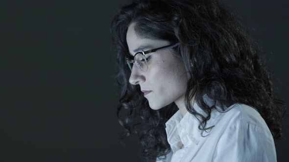 Young Businesswoman Working in Dark Office