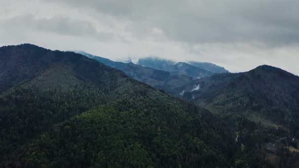 View of the Mountain Valley with a Lake in a Lowland at the Foot of Mountains