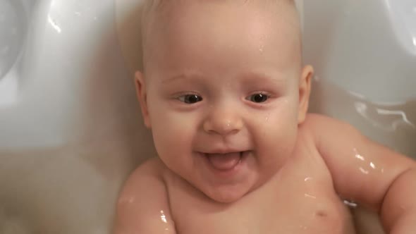 A Closeup of an Adorable Baby Girl Smiling in Bathtub