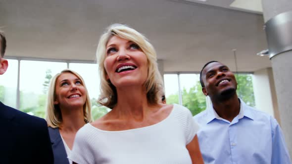 Business executives standing in a conference center lobby