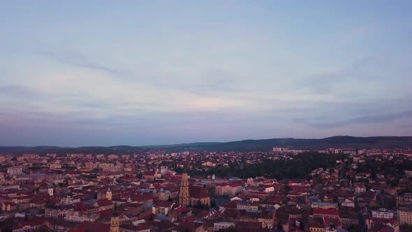 Sunset Red Skyline at Cluj, Romania, Transylvania. Aerial drone over European valley town city with