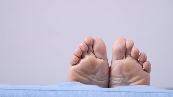 Female Bare Feet on Sofa. Resting