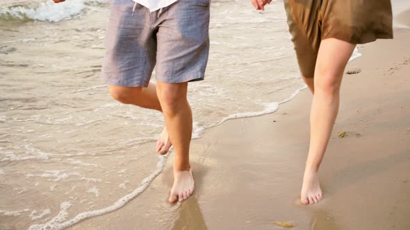 A couple in love runs along the seashore