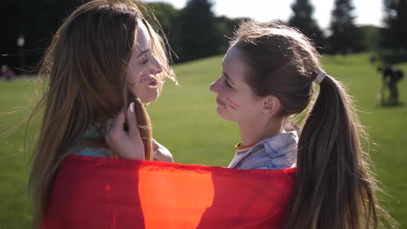 Happy Lesbians Enjoying Closeness Wrapped in Flag
