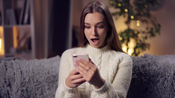 Surprised Woman Looking at Smartphone Screen