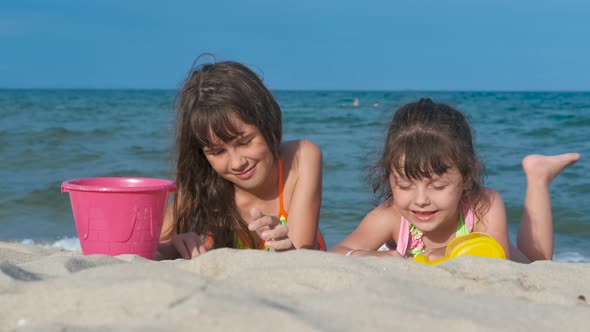 Children play on the beach with toys.