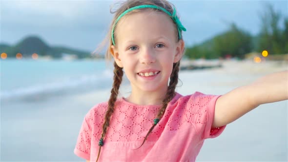 Adorable Little Girl Making Selfie at Tropical White Beach. SLOW MOTION