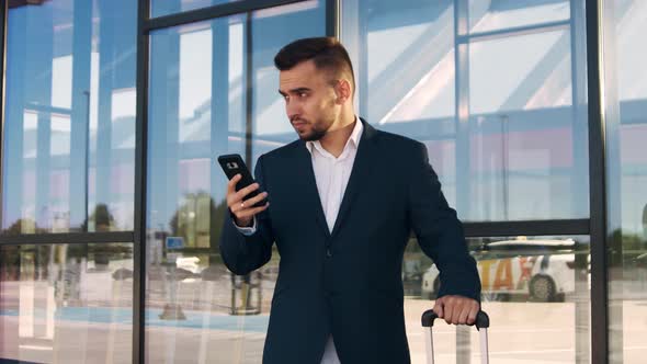 Elegant businessman in airport. Young mail entrepreneur in formalwear.