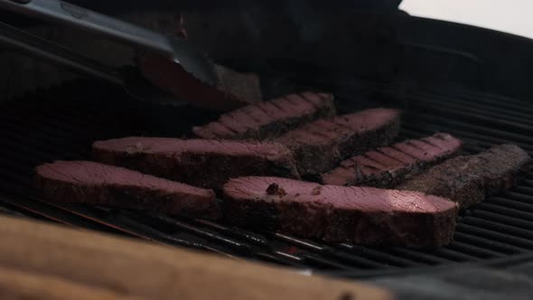 Chef Turn Juicy Pieces of Steak on Grill Outside in Winter