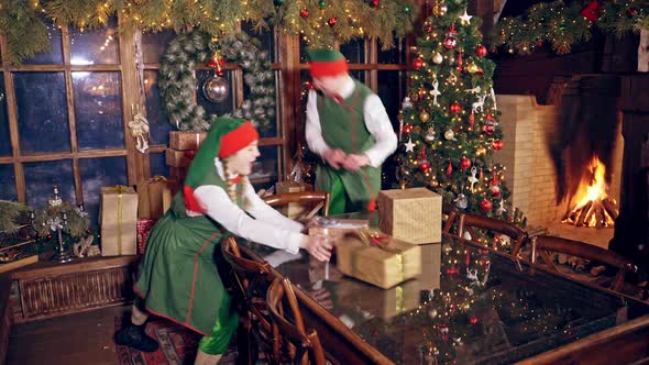 Joyful elves with gift boxes
