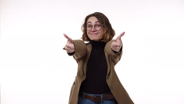 Portrait of Young Attractive European Female with Curly Hair Smiling and Gesturing Thumb Up Excited