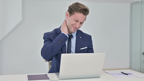 Hardworking Young Businessman Having Neck Pain