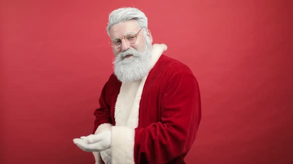 Slow Motion Stylish Cheerful Joyful Happy Bearded Man in Santa Claus Clothing Smiling and Blowing