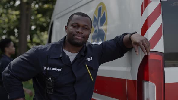 Positive African American Paramedic Posing Near Ambulance Outdoors